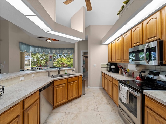 2288 Prague Ln, Punta Gorda, FL 33983 - kitchen with ceiling fan, a sink, light countertops, stainless steel appliances, and backsplash