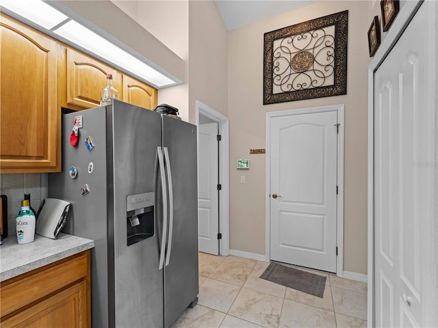 2288 Prague Ln, Punta Gorda, FL 33983 - kitchen featuring light countertops, baseboards, stainless steel refrigerator with ice dispenser, and marble finish floor