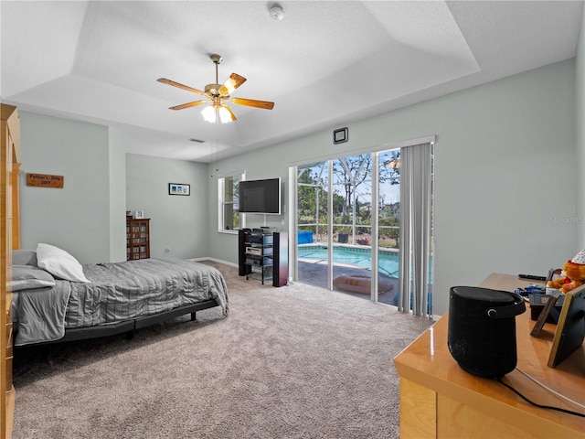 2288 Prague Ln, Punta Gorda, FL 33983 - bedroom featuring a ceiling fan, a tray ceiling, carpet flooring, and access to exterior