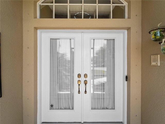 2288 Prague Ln, Punta Gorda, FL 33983 - entryway featuring a textured wall and french doors