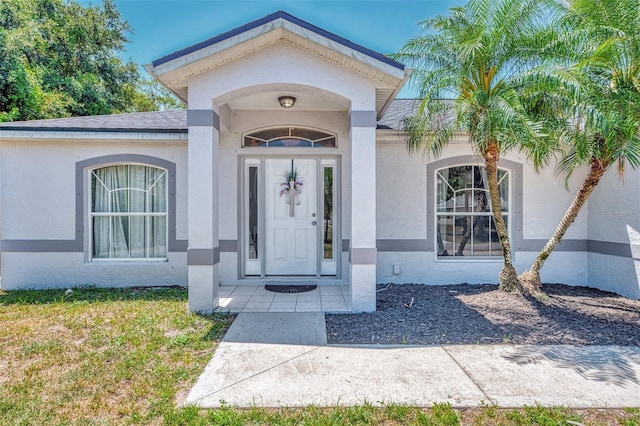 4129 Palisades Ave, North Port, FL 34287 - view of exterior entry with roof with shingles and stucco siding