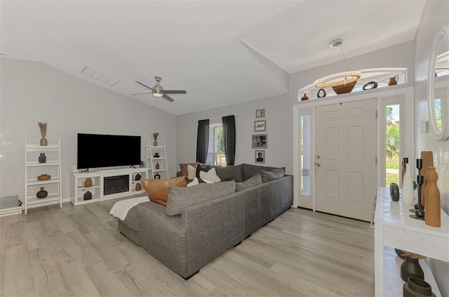 4129 Palisades Ave, North Port, FL 34287 - living room featuring a ceiling fan, visible vents, lofted ceiling, and light wood-style floors