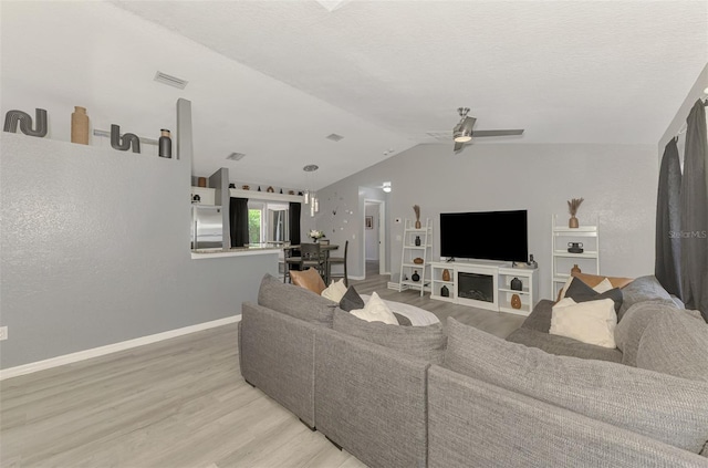 4129 Palisades Ave, North Port, FL 34287 - living area featuring a ceiling fan, vaulted ceiling, light wood-type flooring, and visible vents