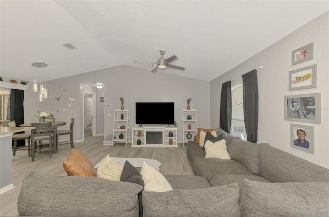 4129 Palisades Ave, North Port, FL 34287 - living room with light wood-style flooring, ceiling fan with notable chandelier, baseboards, vaulted ceiling, and visible vents