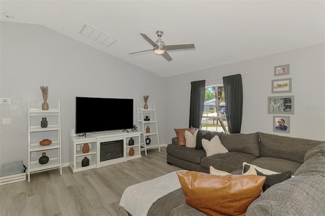 4129 Palisades Ave, North Port, FL 34287 - living room with ceiling fan, vaulted ceiling, wood finished floors, and visible vents