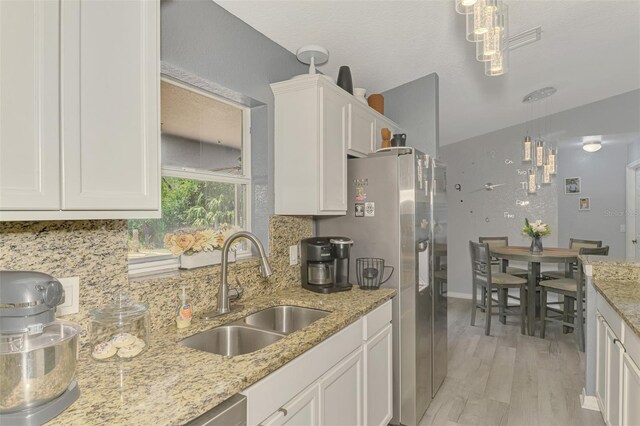 4129 Palisades Ave, North Port, FL 34287 - kitchen featuring a sink, tasteful backsplash, stainless steel refrigerator with ice dispenser, and white cabinets