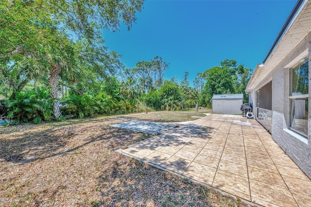 4129 Palisades Ave, North Port, FL 34287 - view of yard featuring a patio, an outbuilding, and a storage unit