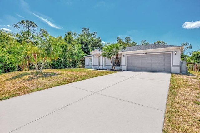4129 Palisades Ave, North Port, FL 34287 - ranch-style house featuring an attached garage, driveway, stucco siding, and a front yard