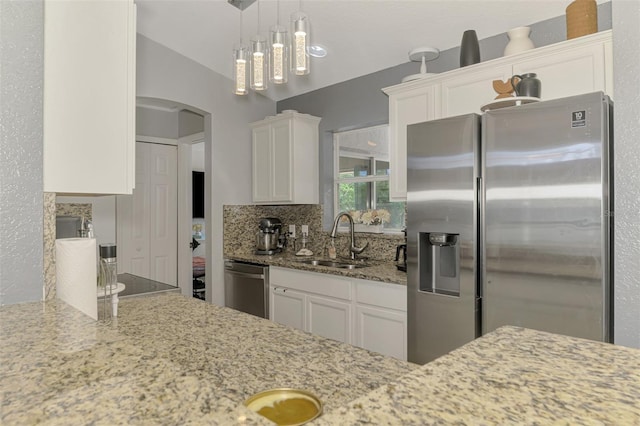 4129 Palisades Ave, North Port, FL 34287 - kitchen with arched walkways, a sink, light stone counters, stainless steel appliances, and white cabinetry