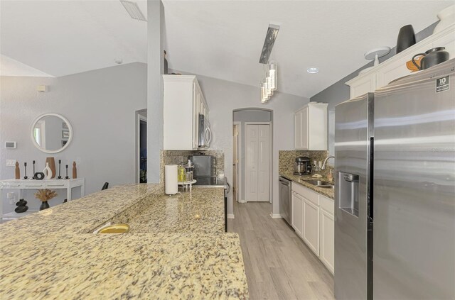 4129 Palisades Ave, North Port, FL 34287 - kitchen with white cabinets, a sink, stainless steel appliances, decorative backsplash, and light wood-type flooring