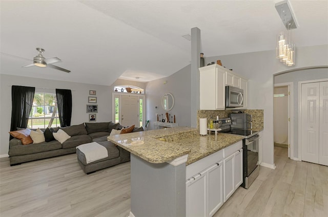 4129 Palisades Ave, North Port, FL 34287 - kitchen featuring white cabinets, light stone countertops, appliances with stainless steel finishes, light wood-style flooring, and decorative backsplash