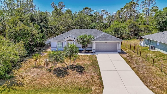 4129 Palisades Ave, North Port, FL 34287 - ranch-style home featuring a garage, fence, stucco siding, central air condition unit, and driveway