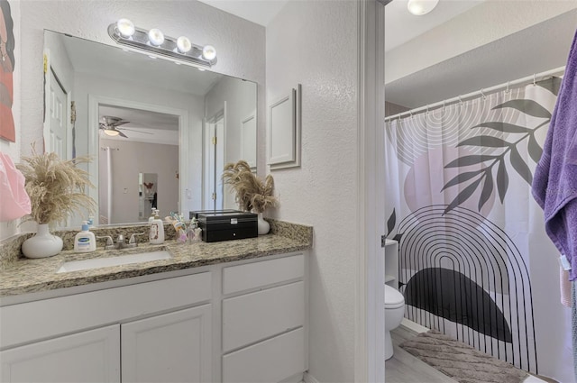 4129 Palisades Ave, North Port, FL 34287 - full bath featuring vanity, a textured wall, toilet, ceiling fan, and a shower with curtain