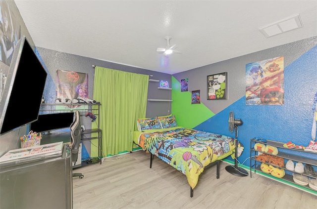 4129 Palisades Ave, North Port, FL 34287 - bedroom featuring a ceiling fan, a textured wall, visible vents, and wood finished floors