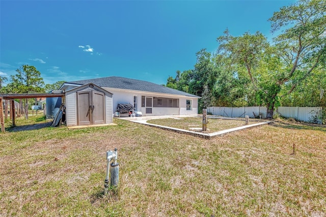 4129 Palisades Ave, North Port, FL 34287 - rear view of house with a lawn, an outdoor structure, fence, and a shed