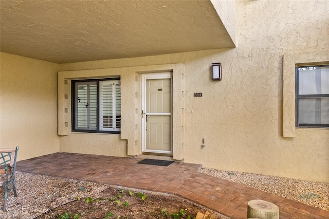 3230 Southshore Dr Unit 33A, Punta Gorda, FL 33955 - doorway to property featuring stucco siding and a patio area