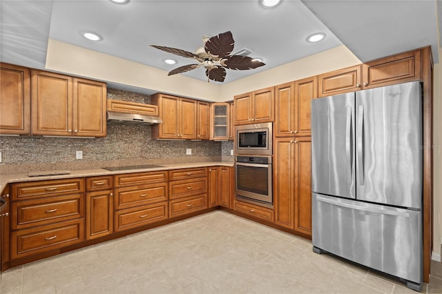 3230 Southshore Dr Unit 33A, Punta Gorda, FL 33955 - kitchen featuring stainless steel appliances, brown cabinetry, under cabinet range hood, ceiling fan, and backsplash