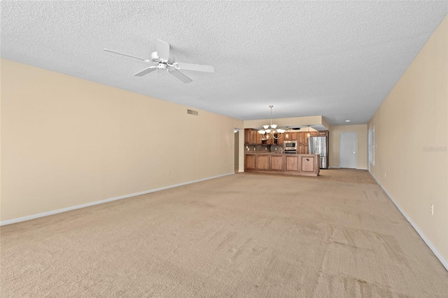 3230 Southshore Dr Unit 33A, Punta Gorda, FL 33955 - unfurnished living room with a chandelier, light carpet, baseboards, a textured ceiling, and ceiling fan