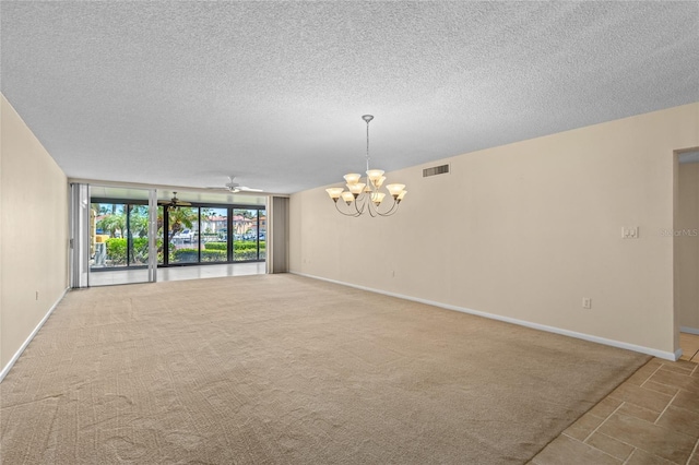 3230 Southshore Dr Unit 33A, Punta Gorda, FL 33955 - carpeted spare room with a chandelier, floor to ceiling windows, a textured ceiling, a ceiling fan, and baseboards