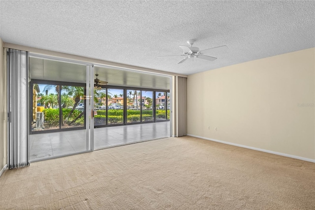 3230 Southshore Dr Unit 33A, Punta Gorda, FL 33955 - unfurnished room with a ceiling fan, carpet flooring, baseboards, and a textured ceiling