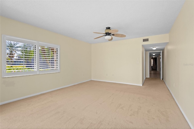 3230 Southshore Dr Unit 33A, Punta Gorda, FL 33955 - empty room featuring light colored carpet, baseboards, ceiling fan, and a textured ceiling