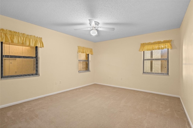 3230 Southshore Dr Unit 33A, Punta Gorda, FL 33955 - carpeted spare room with healthy amount of natural light, ceiling fan, baseboards, and a textured ceiling
