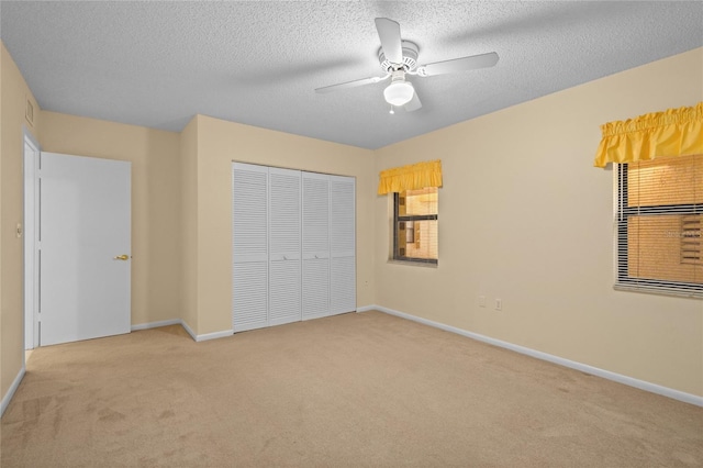 3230 Southshore Dr Unit 33A, Punta Gorda, FL 33955 - unfurnished bedroom featuring carpet floors, a closet, baseboards, a textured ceiling, and ceiling fan