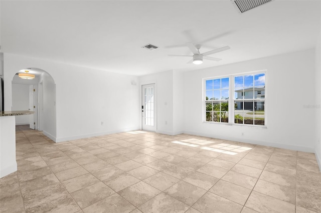 124 Rotonda Cir, Rotonda West, FL 33947 - empty room with visible vents, ceiling fan, baseboards, and arched walkways