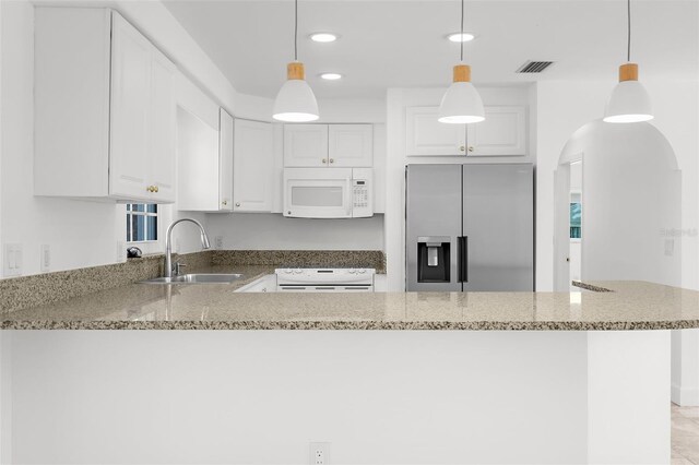 124 Rotonda Cir, Rotonda West, FL 33947 - kitchen with range, a sink, visible vents, white microwave, and stainless steel fridge