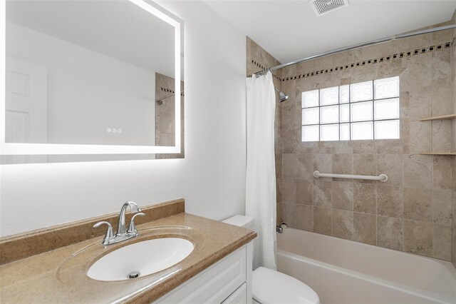 124 Rotonda Cir, Rotonda West, FL 33947 - bathroom featuring shower / bath combo, visible vents, toilet, and vanity