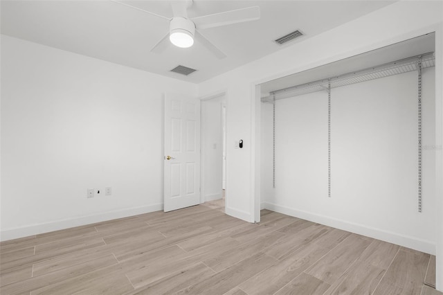 124 Rotonda Cir, Rotonda West, FL 33947 - unfurnished bedroom with light wood finished floors, a ceiling fan, visible vents, and baseboards