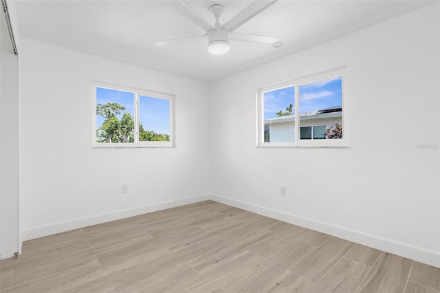 124 Rotonda Cir, Rotonda West, FL 33947 - spare room featuring a wealth of natural light, light wood finished floors, and baseboards