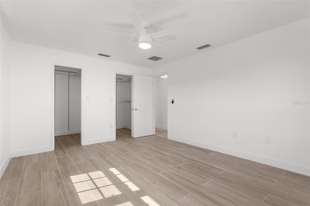 124 Rotonda Cir, Rotonda West, FL 33947 - unfurnished bedroom featuring visible vents, light wood-type flooring, baseboards, and a spacious closet