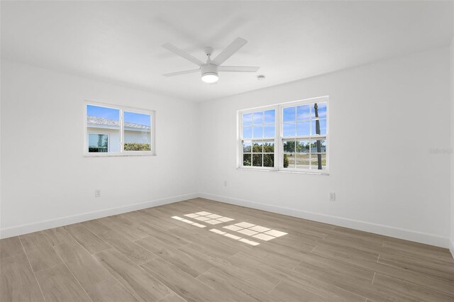 124 Rotonda Cir, Rotonda West, FL 33947 - unfurnished room featuring ceiling fan, light wood finished floors, and baseboards