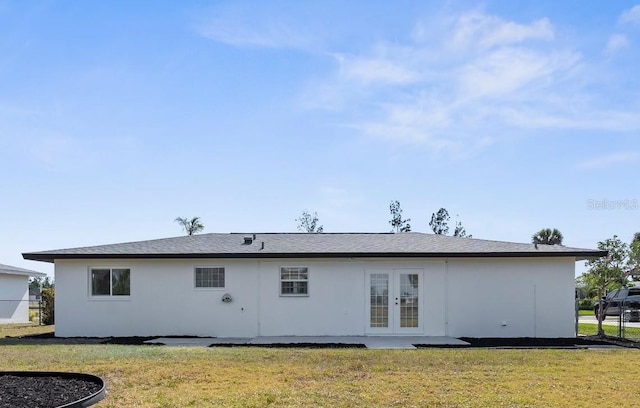 124 Rotonda Cir, Rotonda West, FL 33947 - back of property with french doors, stucco siding, and a yard