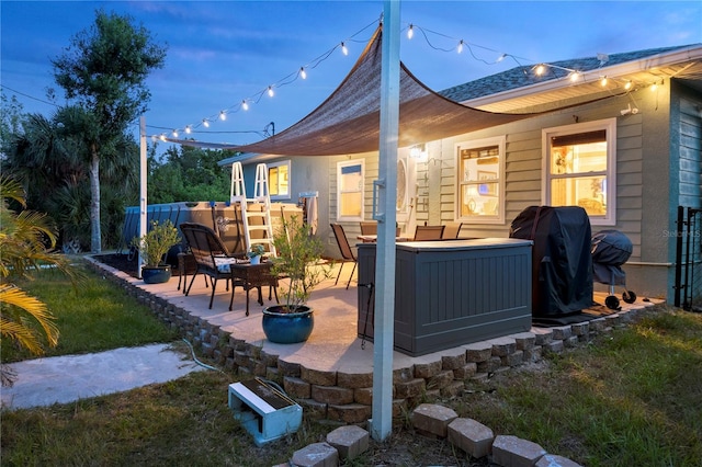 view of patio / terrace with a hot tub and grilling area