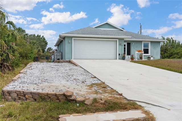 view of front of home featuring a garage, stucco siding, and driveway