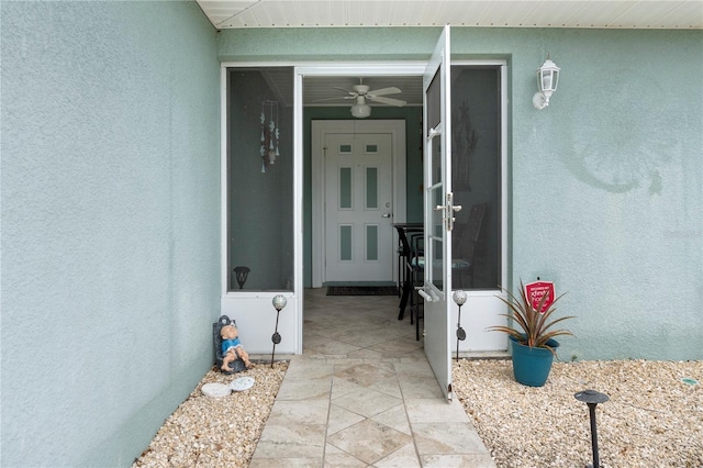 view of exterior entry featuring stucco siding
