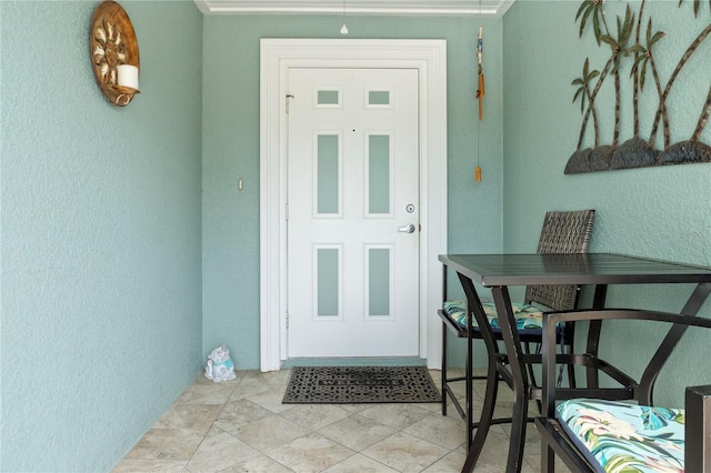 entrance to property featuring outdoor dining area and stucco siding