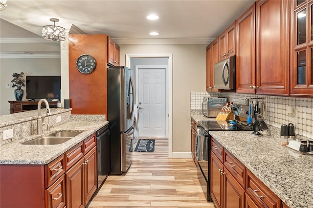 kitchen with crown molding, tasteful backsplash, a sink, light wood finished floors, and black appliances
