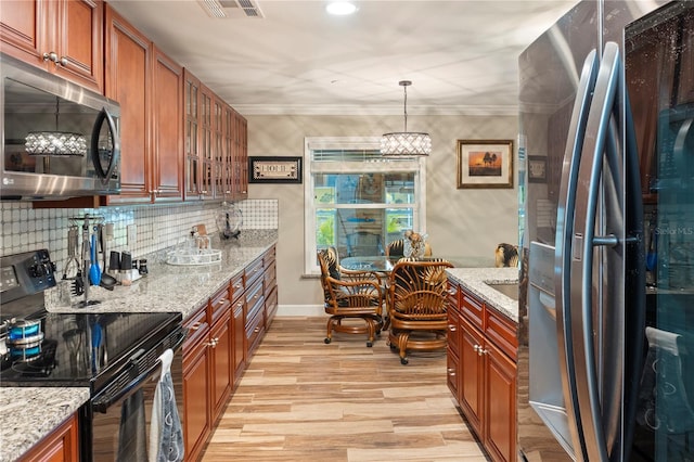 kitchen featuring stainless steel appliances, light stone countertops, visible vents, and light wood-style flooring