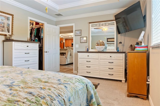 bedroom with crown molding, light carpet, a spacious closet, visible vents, and a closet