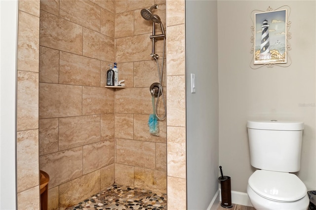 full bath with a tile shower and toilet