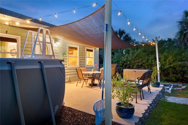 view of patio featuring a jacuzzi and outdoor dining space