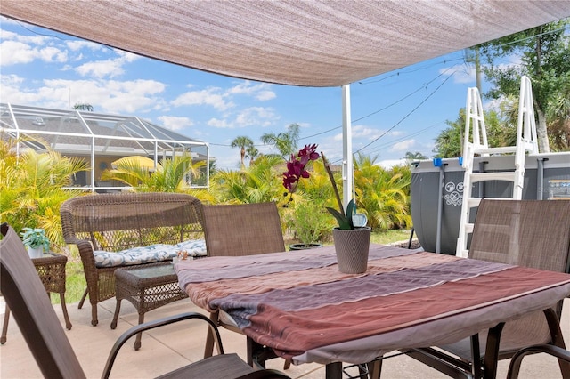 view of patio featuring glass enclosure