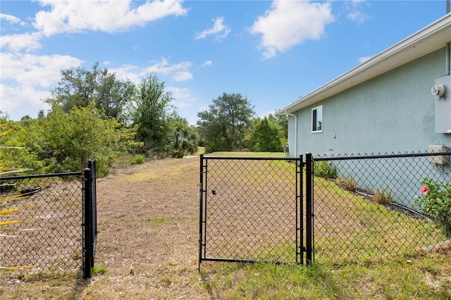 view of yard with fence and a gate