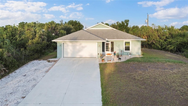 single story home featuring a garage, a front yard, roof with shingles, stucco siding, and driveway