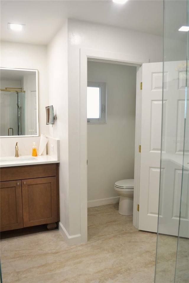 1118 NW 17th St, Cape Coral, FL 33993 - full bathroom with vanity, toilet, baseboards, and a stall shower