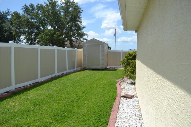 1118 NW 17th St, Cape Coral, FL 33993 - view of yard with an outbuilding, a fenced backyard, and a storage unit