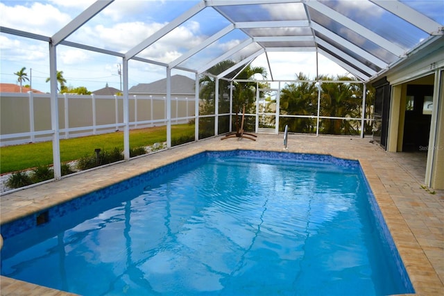 1118 NW 17th St, Cape Coral, FL 33993 - view of swimming pool with a fenced in pool, fence, a patio, and glass enclosure